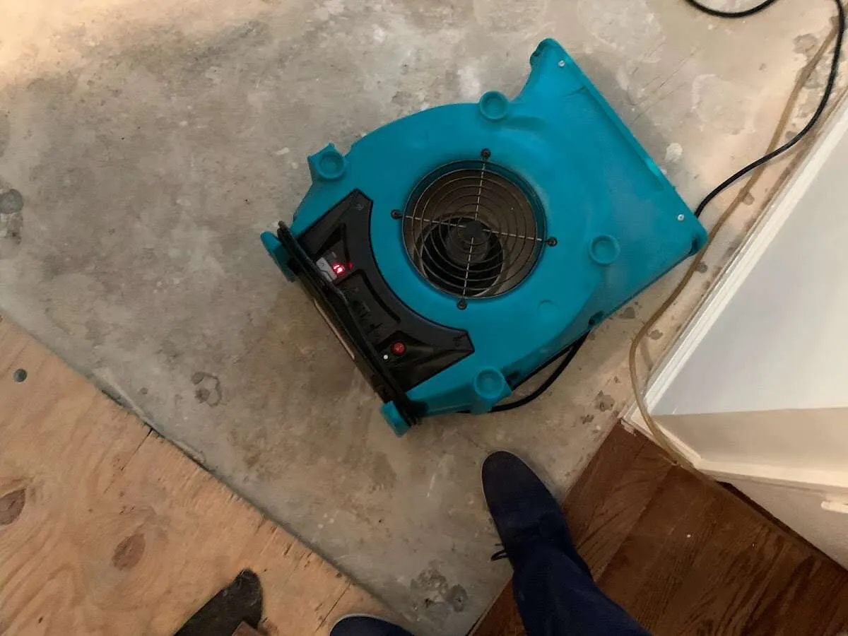 Air mover drying subfloor during Commercial Water Damage Restoration in North Lakes